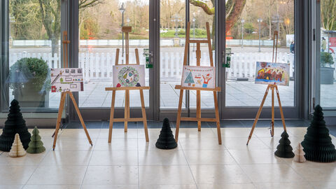 Drei weihnachtliche gemalte Kinderbilder auf Staffeleien