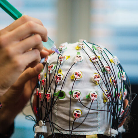 Eine Person trägt eine mit Kabeln verbundene Maske.